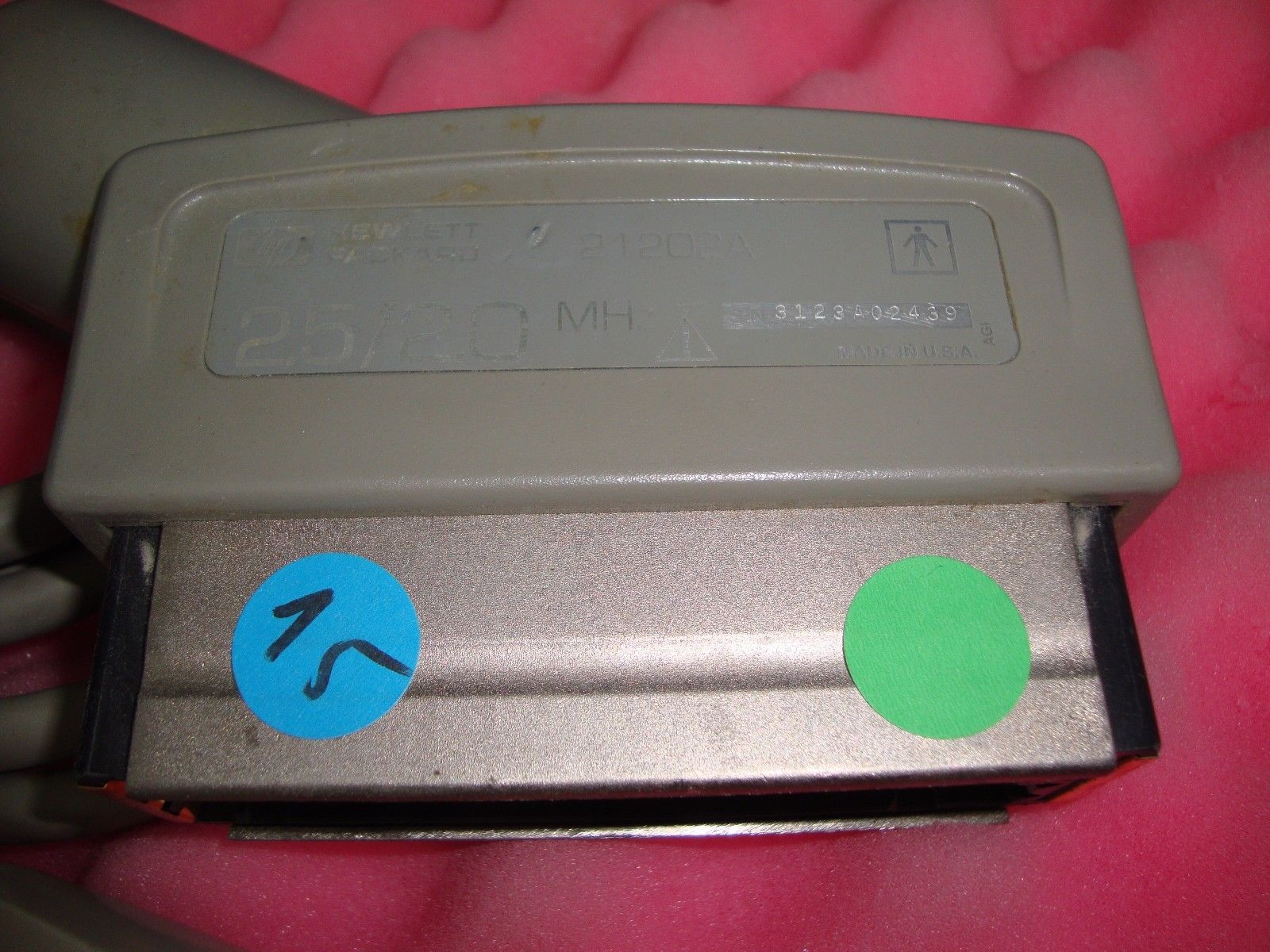 a close up of a metal object with some stickers on it