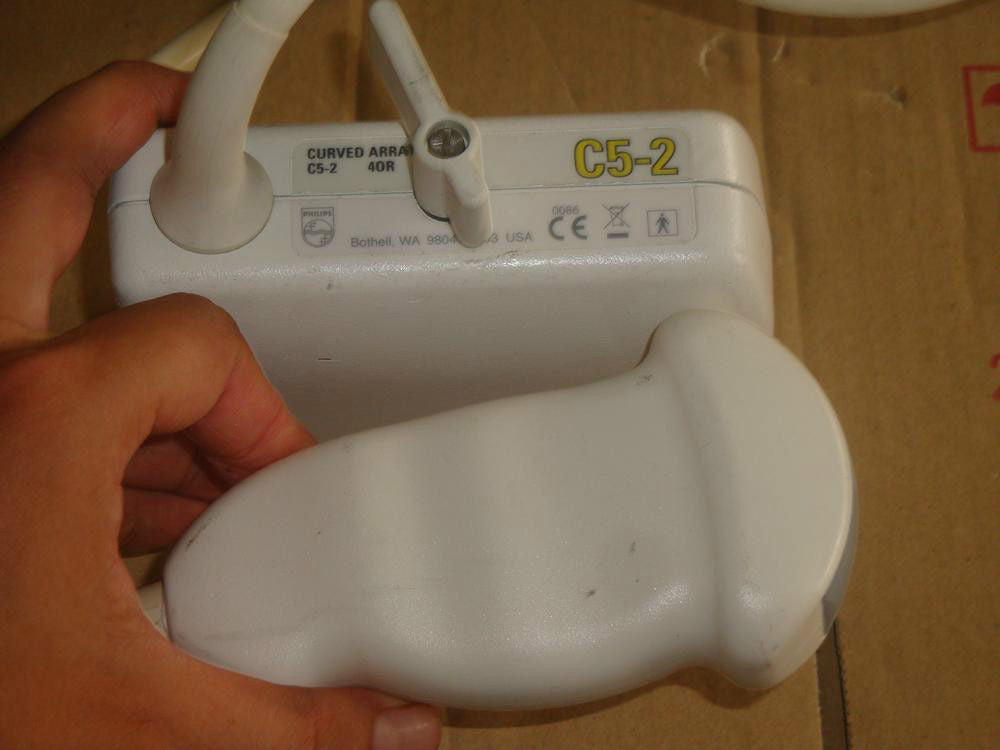 a person holding a white probe in hand