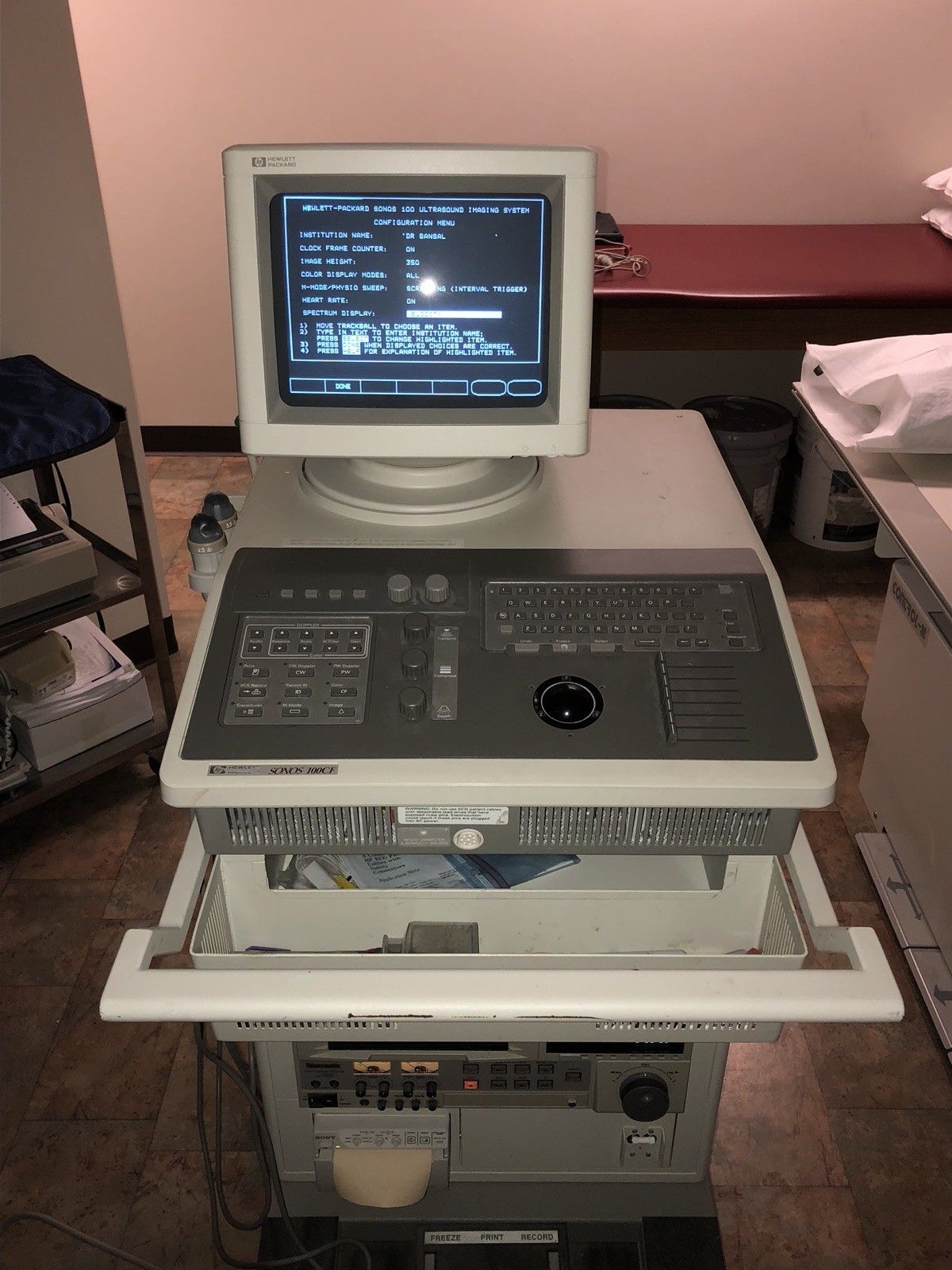 a computer sitting on top of a stack of electronics