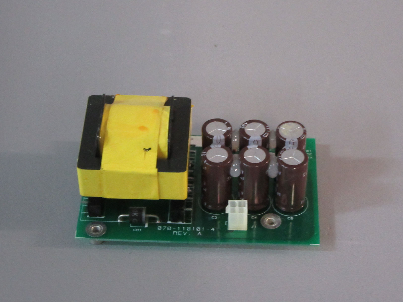 a circuit board with a yellow and black device