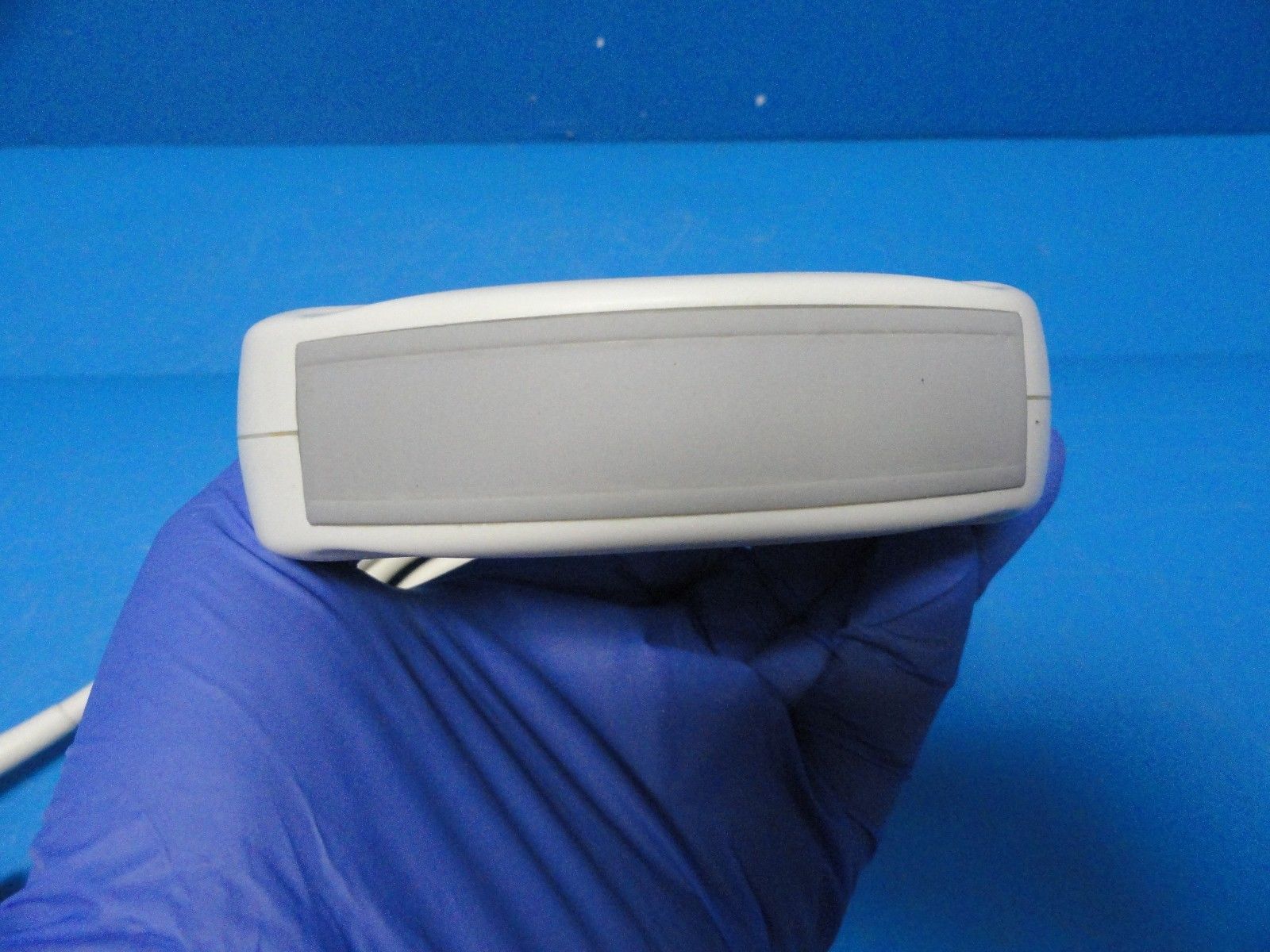 hands holding up probe head