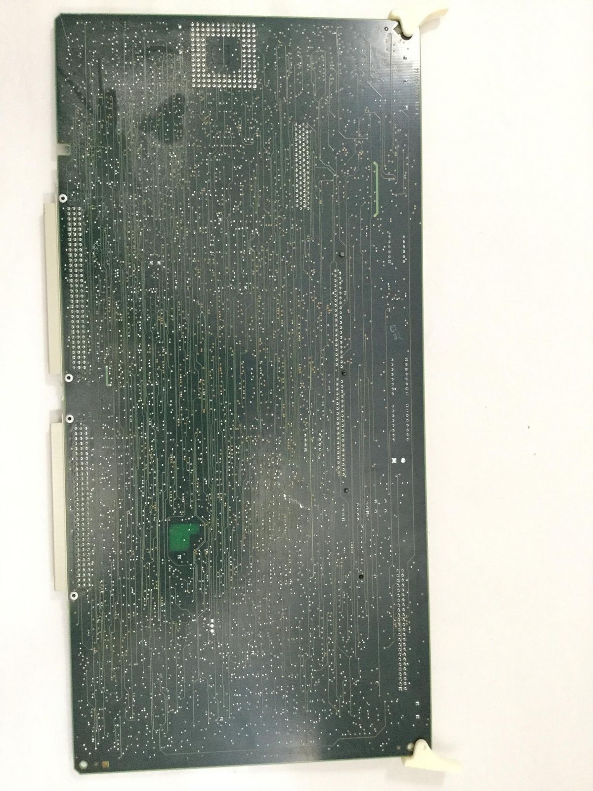 a piece of electronic circuit board sitting on top of a white wall