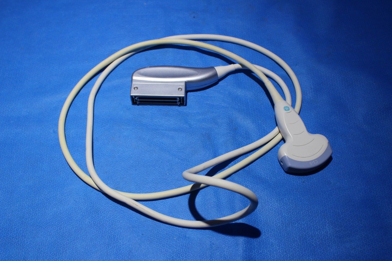 a cord connected to aprobe on a blue surface