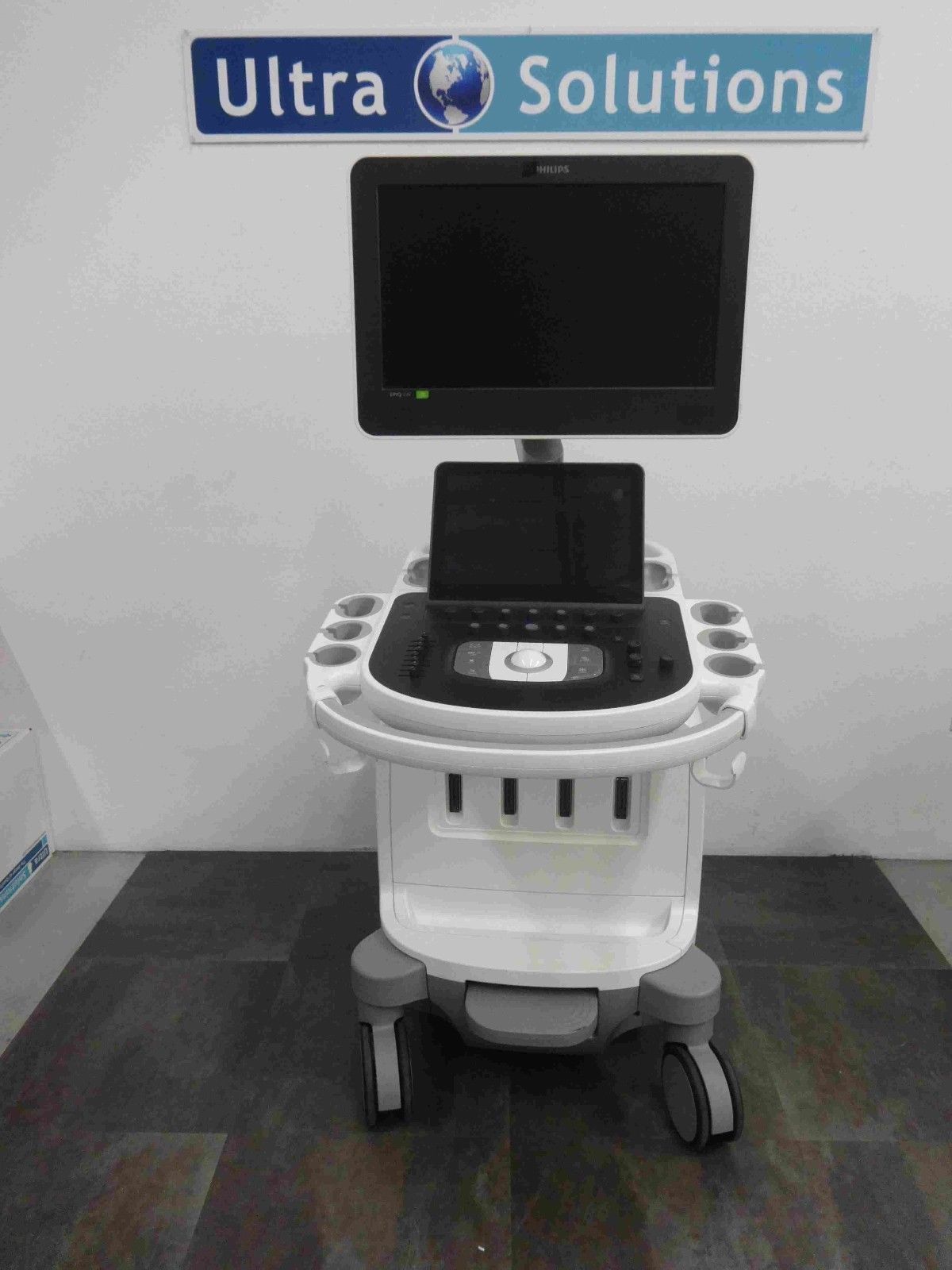 a medical cart with a monitor on top of it