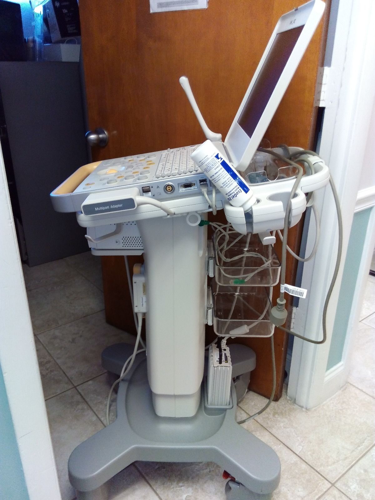 a laptop computer sitting on top of a medical cart