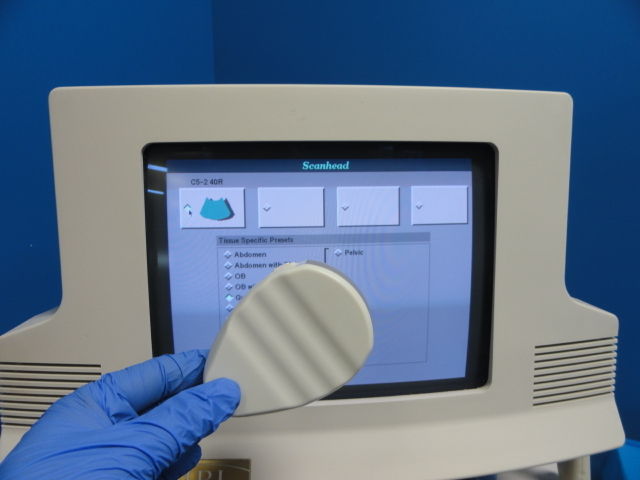 a person in blue gloves touching a monitor