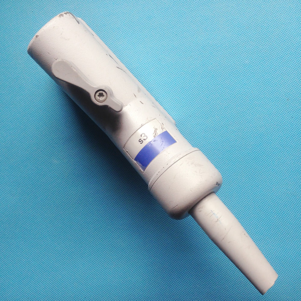 a white electric probe head on a blue surface
