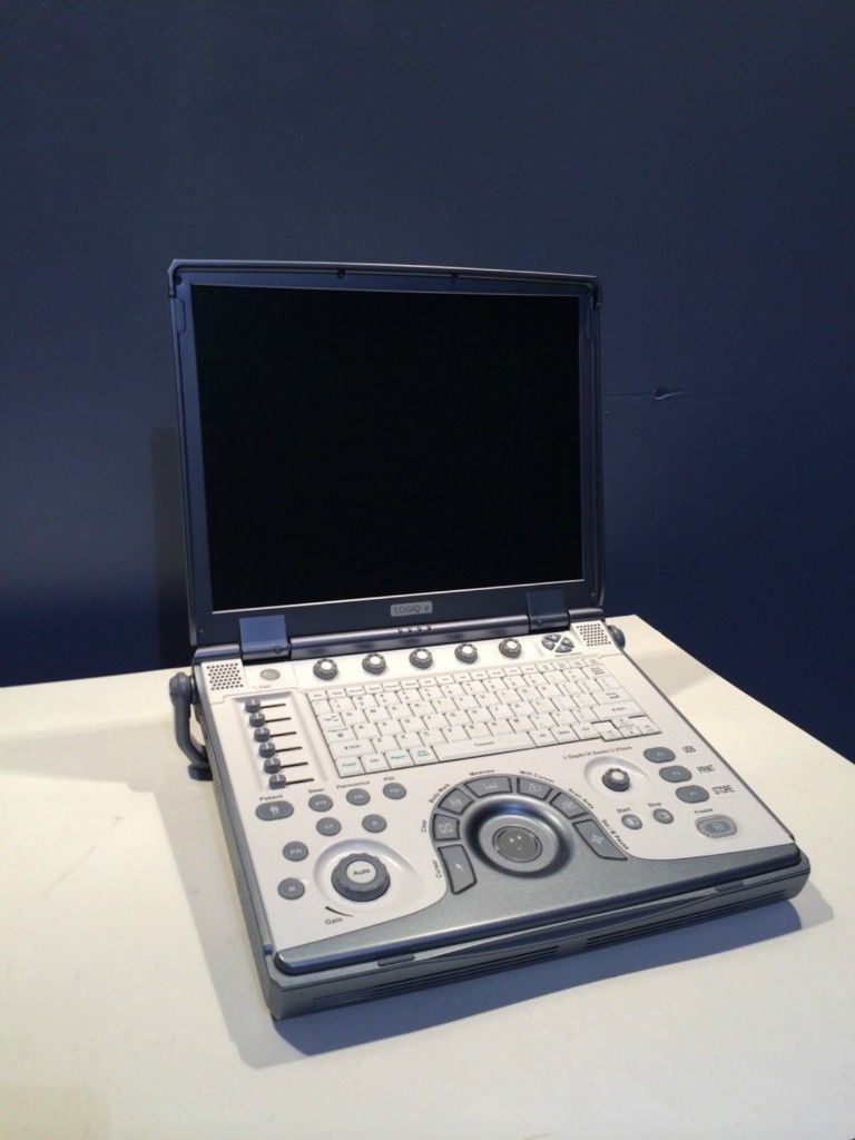 a laptop computer sitting on top of a white table