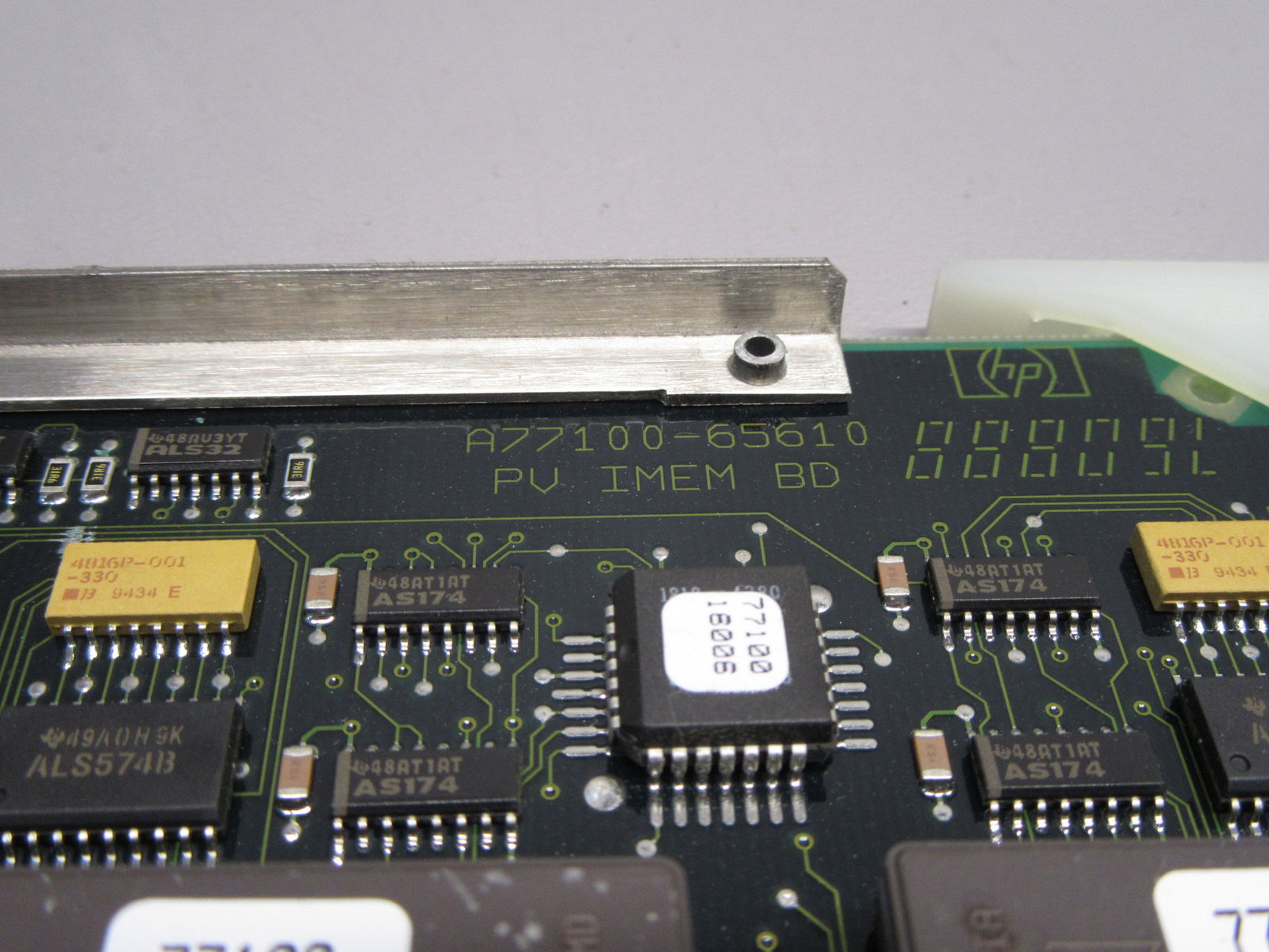 a close up of a computer chip with a metal object in the background