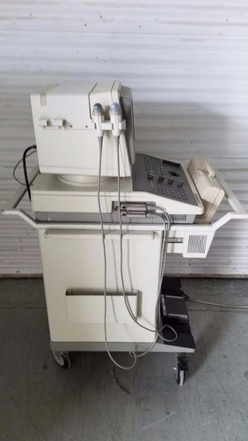 a white machine sitting on top of a floor next to a wall